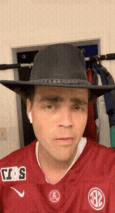 Man In Cowboy Hat And Maroon Jersey GIF