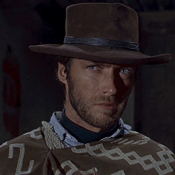 Man In Cowboy Hat And Poncho Blowing Bubbles GIF