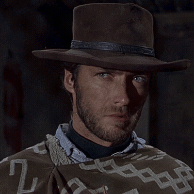 Man In Cowboy Hat And Poncho Blowing Bubbles GIF