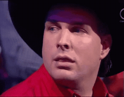 Man In Cowboy Hat And Red Shirt Making Funny Face GIF