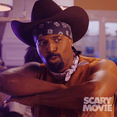 Man In Cowboy Hat And Scary Movie Shirt GIF