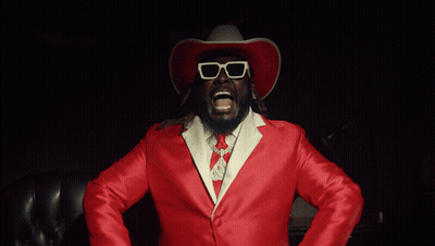 Man In Cowboy Hat And Sunglasses Holding Guns GIF