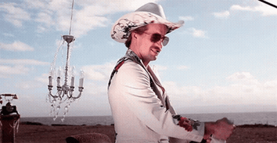 Man In Cowboy Hat And Sunglasses In Front Of Chandelier GIF