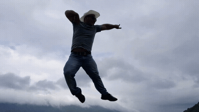 Man In Cowboy Hat And Sunglasses Jumping GIF
