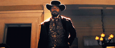 Man In Cowboy Hat And Vest In Dark Room GIF