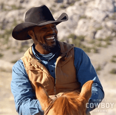 Man In Cowboy Hat And Vest Laughing On Horse GIF