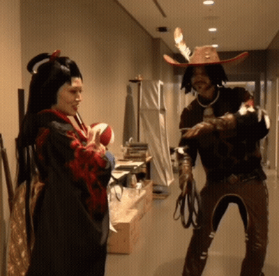Man In Cowboy Hat And Woman In Kimono Standing In Hallway GIF