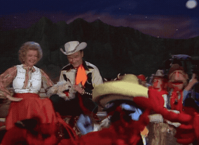 Man in Cowboy Hat and Woman in Sombrero Dancing