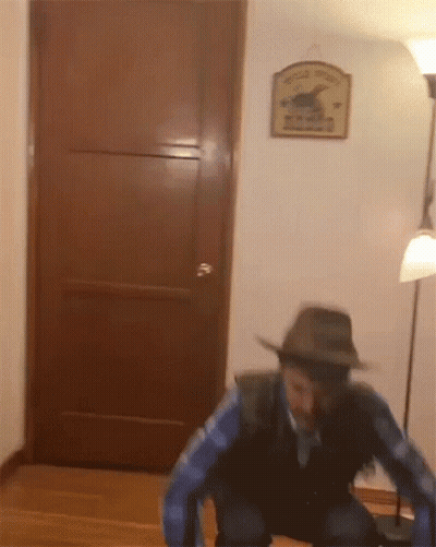 Man In Cowboy Hat At Wooden Door With Wild West Sign GIF