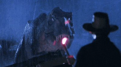 Man In Cowboy Hat Beside Dinosaur GIF