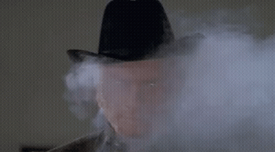 Man In Cowboy Hat Covered In Smoke GIF