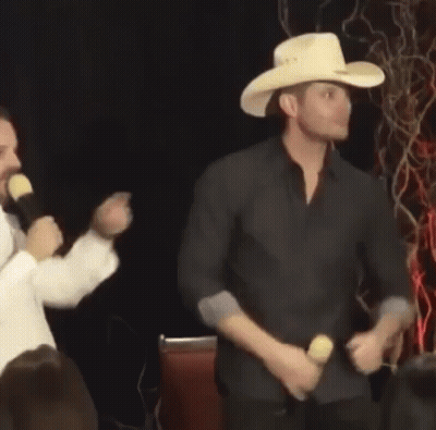 Man In Cowboy Hat Dancing In Front Of Microphone GIF