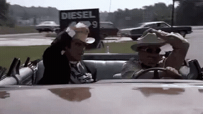 Man In Cowboy Hat Driving Beside Diesel Sign GIF