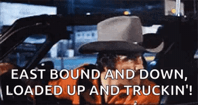 Man In Cowboy Hat Driving Car East Bound And Down Loaded Up And Truckin GIF