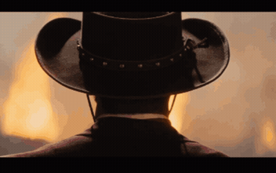 Man In Cowboy Hat Facing Flames GIF