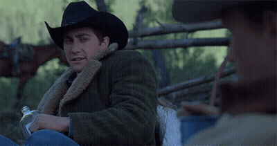 Man In Cowboy Hat Holding Bottle Of Alcohol GIF