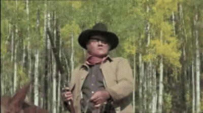 Man In Cowboy Hat Holding Gun GIF
