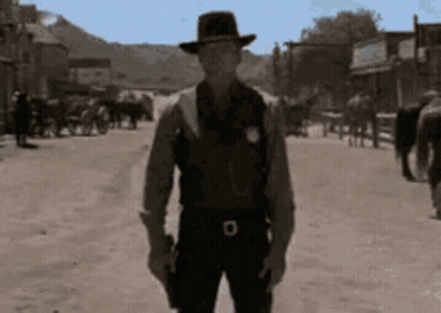 Man In Cowboy Hat Holding Gun GIF