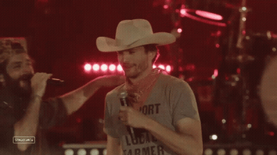 Man In Cowboy Hat Holding Microphone GIF