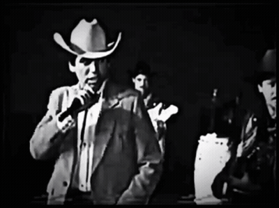 Man In Cowboy Hat Holding Microphone GIF
