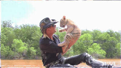 Man In Cowboy Hat Holding Small White Tiger GIF