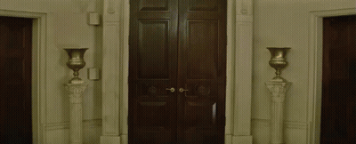 Man In Cowboy Hat Holding Umbrella Walking Through Doorway GIF