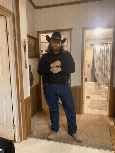 Man In Cowboy Hat In Hallway GIF