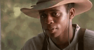 Man In Cowboy Hat Looking At Camera GIF
