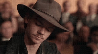 Man In Cowboy Hat Looking Down In Front Of Crowd GIF