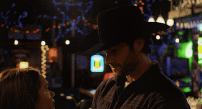 Man In Cowboy Hat Looks At Woman GIF