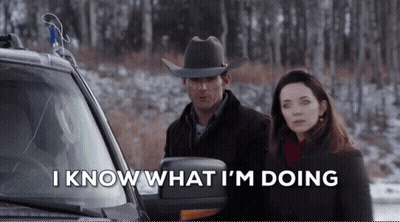 Man In Cowboy Hat Next To Woman In Snowy Forest GIF