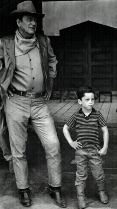 Man In Cowboy Hat Next To Young Boy GIF