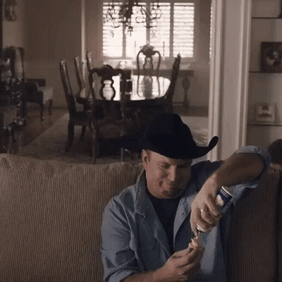 Man In Cowboy Hat Opening Beer GIF