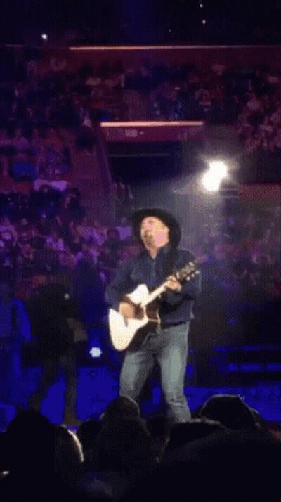 Man In Cowboy Hat Playing Guitar For Crowd GIF