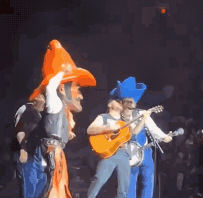 Man In Cowboy Hat Playing Guitar On Stage GIF