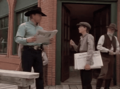 Man In Cowboy Hat Reading Paper GIF