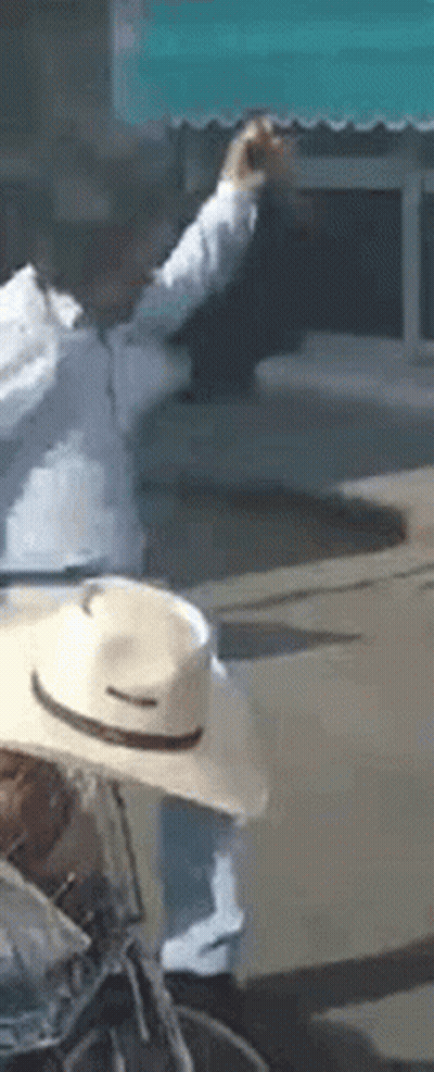 Man In Cowboy Hat Riding Bicycle GIF