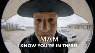 Man In Cowboy Hat Saying Mam I Know You're In There In Front Of Police Car GIF