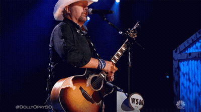 Man In Cowboy Hat Singing Into Microphone #Dolly Opry50 GIF