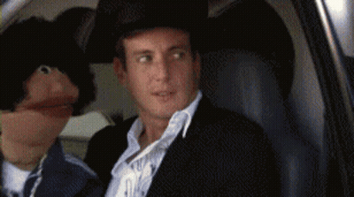 Man in Cowboy Hat Sitting in Car With Puppet