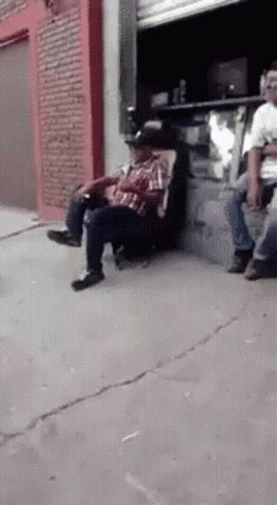 Man In Cowboy Hat Sitting On Sidewalk Chair GIF