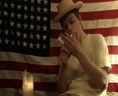 Man In Cowboy Hat Smoking Cigarette GIF