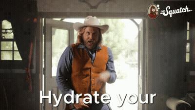 Man In Cowboy Hat Standing By Hydrate Your Door GIF