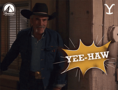 Man In Cowboy Hat Standing In Front Of Yellow Yee-Haw Sign GIF