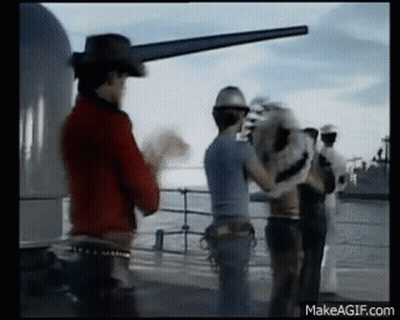 Man In Cowboy Hat Standing Next To Men On Boat GIF