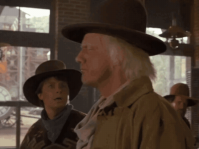 Man In Cowboy Hat Standing Next To Woman GIF