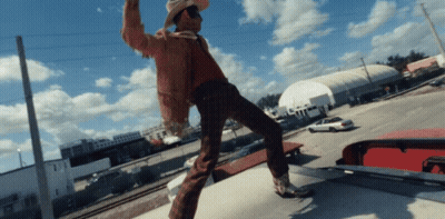 Man In Cowboy Hat Standing On Car Roof GIF
