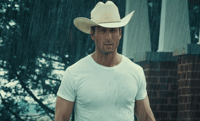 Man In Cowboy Hat Stands In Rain GIF