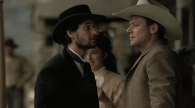 Man In Cowboy Hat Talking To Suit GIF