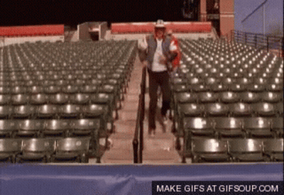 Man In Cowboy Hat Walking Down Stadium Stairs GIF